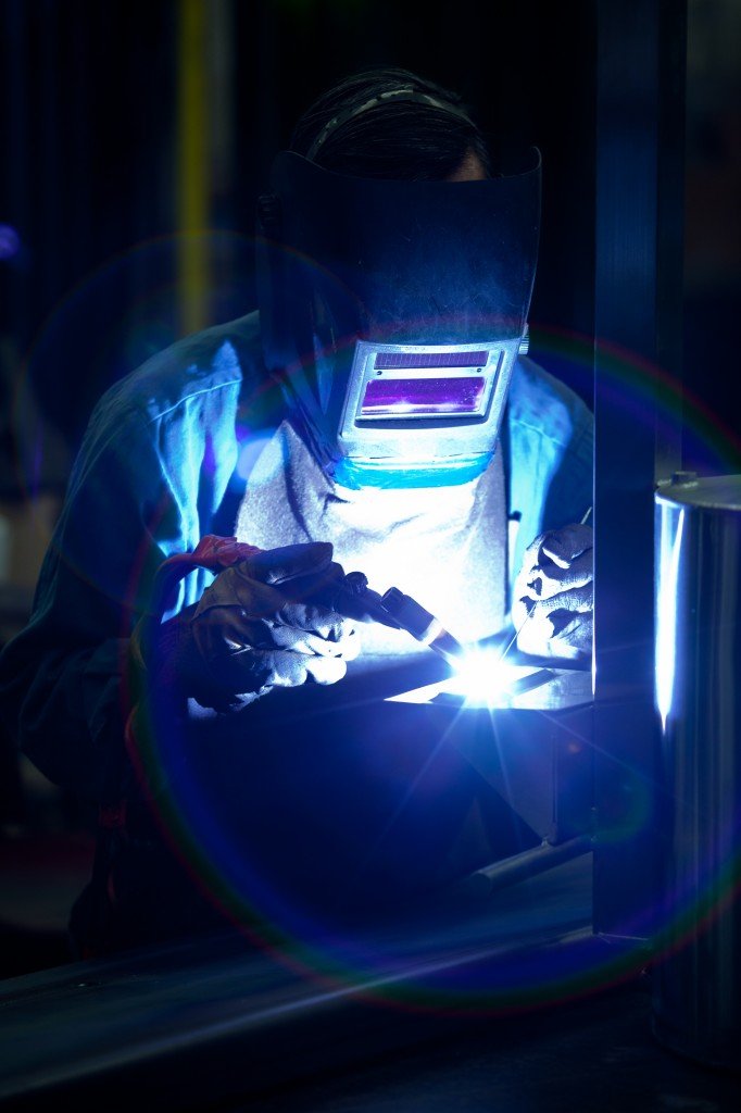 Welder fabricating a steel component at Pressform
