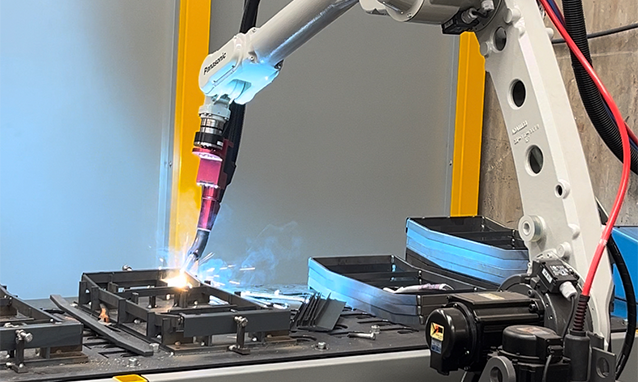 Panasonic robotic welding cell welding a jigged steel component at Pressform