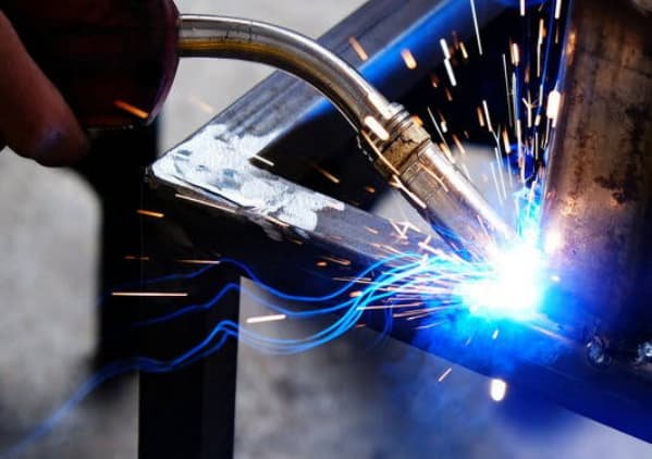 Welder fabricating a steel frame in Pressform's Bassendean workshop